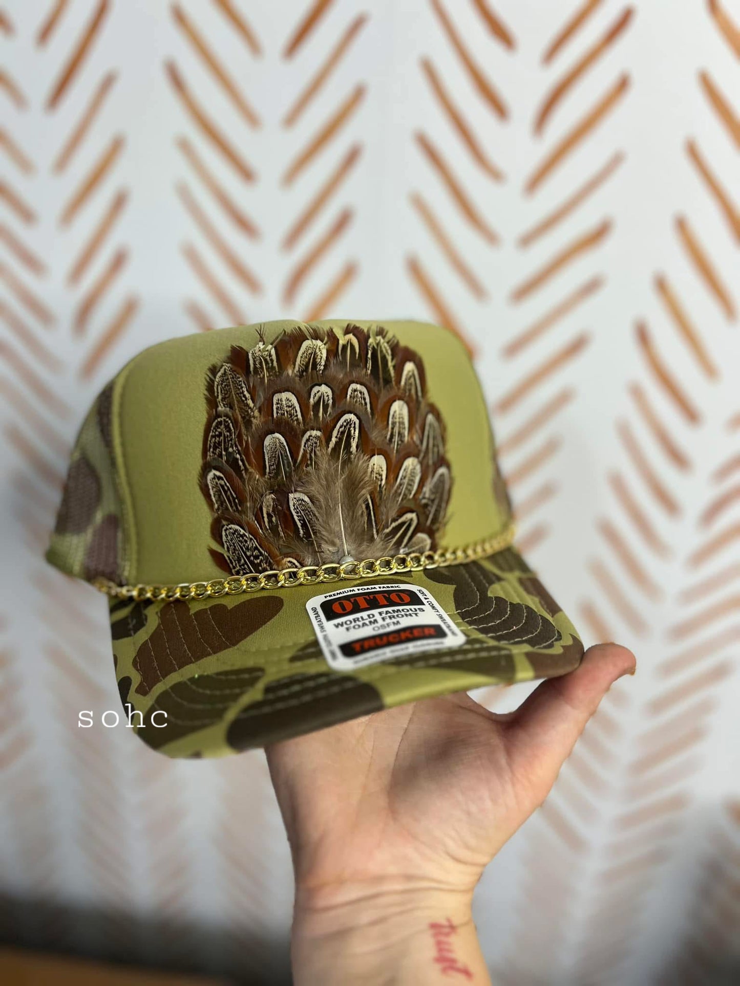 green camo feathered trucker